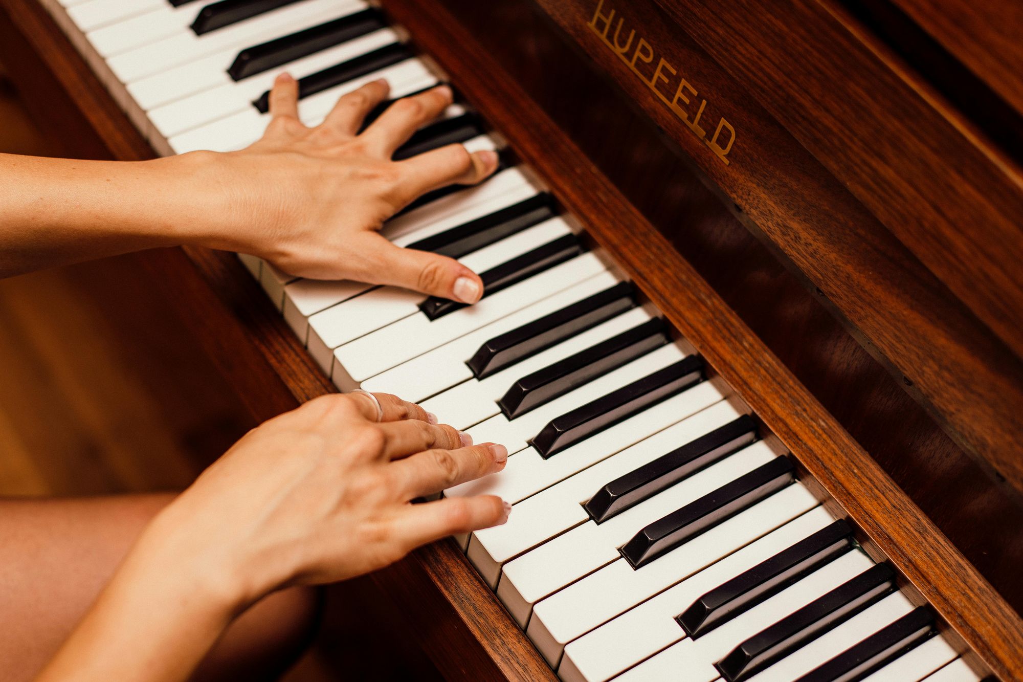 Close-up of hands playing piano